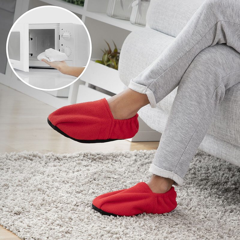 Zapatillas calentables puestas en el sofá